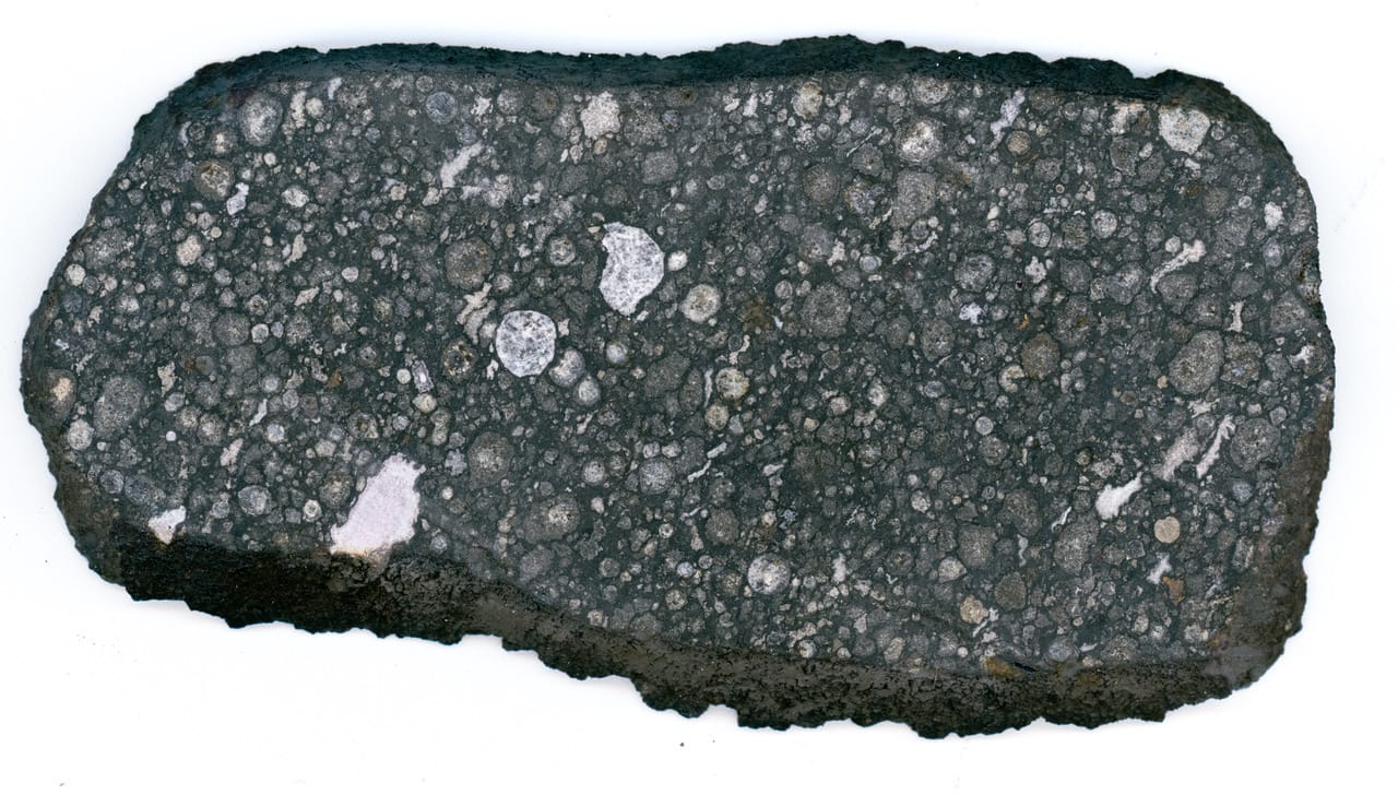 Photo of an interior slice of the Allende meteorite, with lots of CAIs visible.